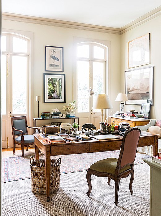 Columns and a pair of sea-grass mats divide Julia’s office area from her sitting area. She’s layered the natural-fiber rugs with antique Oriental rugs and an unusual striped dhurrie, which she bought from her friend Suzanne Rheinstein’s Los Angeles store, Hollyhock.
