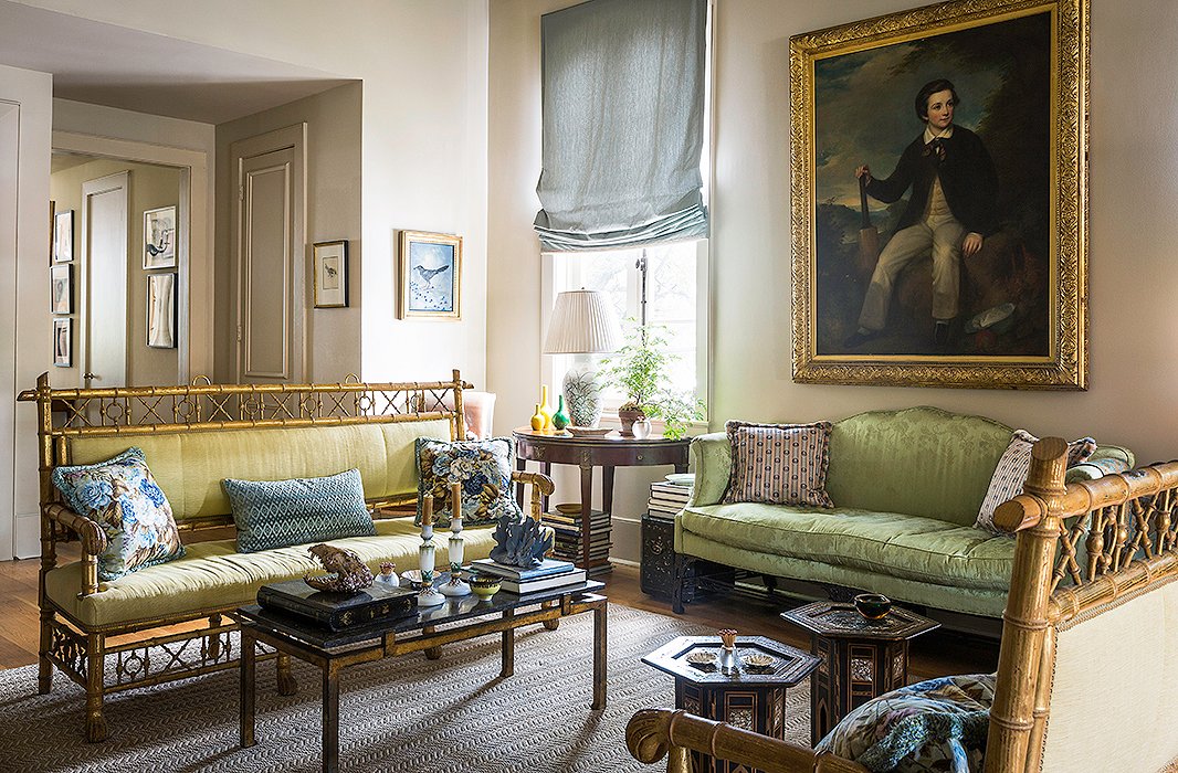 In her more formal living room, Julia mixes a Chinese Chippendale sofa (which belonged to both her grandmother and her great-grandmother) with a pair of gilded Regency settees and Indian cocktail tables. “I’ve become an accidental eclectic,” she jokes. The author reupholstered the sofa in a green silk damask almost identical to its original silk.
Julia found the gilded bamboo benches at Ann Koerner Antiques in New Orleans. “I saw them and I knew I had to have them,” Julia says. “They sat in storage until I had a place to put them. I love any kind of paw feet, and I love bamboo, so they were perfect. And for pieces that look so nutty and over the top, they are really deep and comfortable.”