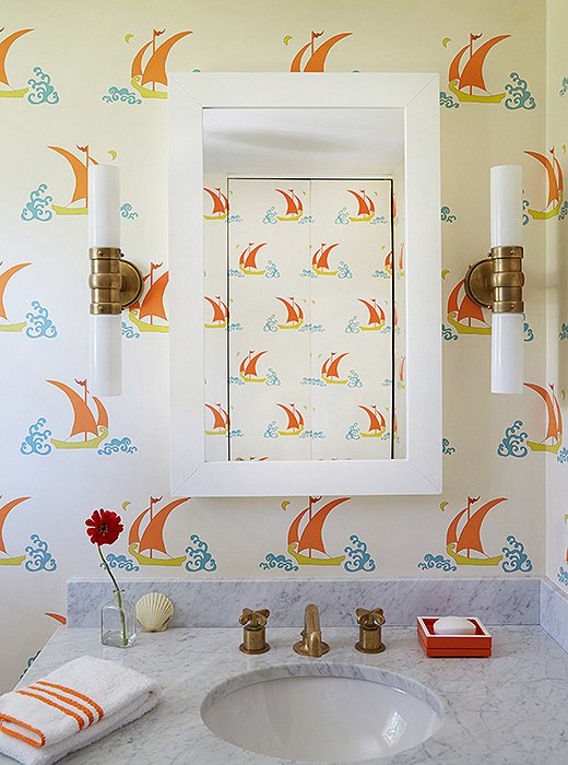 A small bathroom space provides the perfect opportunity to go a little wild—and Katie Ridder’s Betelecat wallpaper is as fun as its name. The nautical motif is in full force here, but as usual, Elizabeth put her own spin on it. “I didn’t want to just do the traditional blue and white—sometimes I feel like that’s all I see here. I needed something a little different!”
