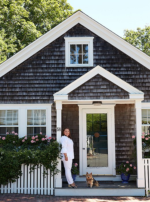 Elizabeth and the family’s Norwich terrier, Lily Bear, strike a welcoming pose at the cottage, which was once a turn-of-the-century butcher shop.<br />