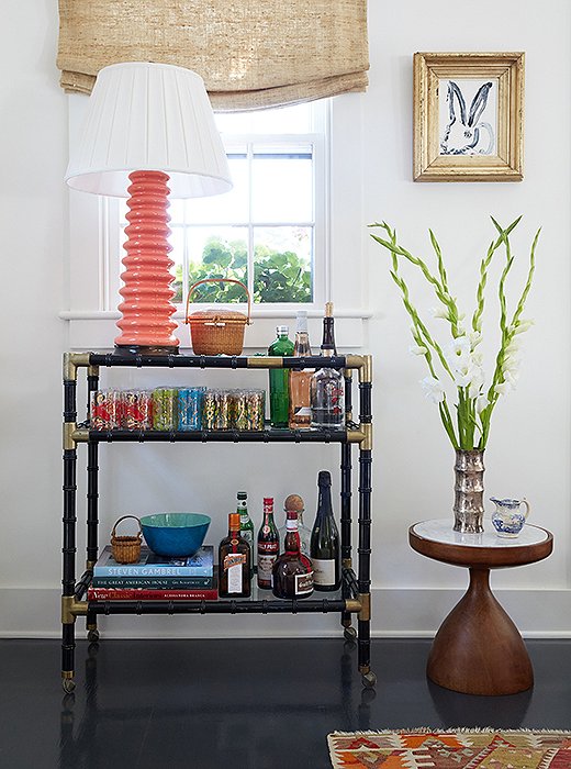 “It’s a real mix of high-low,” says Elizabeth of the space, pointing out the bar cart from Paris, a Hunt Slonem framed bunny print, and the sinuous midcentury-style table. But the most meaningful piece here is undoubtedly a Nantucket “lightship basket” passed down from her grandmother. Baskets like this one were originally made by the crewmen of lightships as a way to pass time while away at sea.
