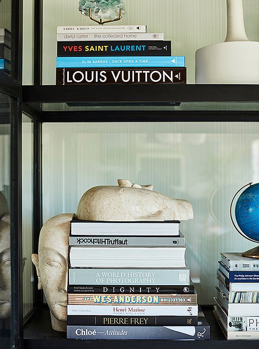 The glass cabinet invites the eye to wander over Sophia’s collection of globes and other curios along with her mini library of coffee table books.
