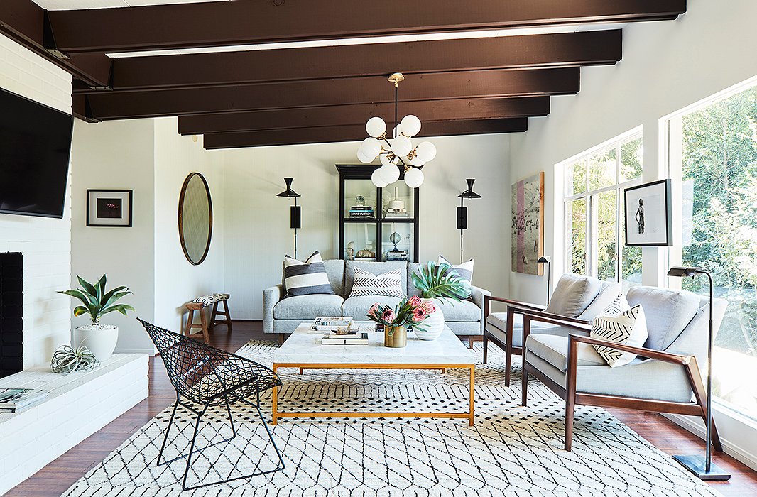 Glamour is also part of Palm Springs chic. Hence the marble top and golden base of the coffee table (find a similar one here) and the golden accents of the chandelier. Find the armchairs here. Design by One Kings Lane Interior Design. Photo by Joe Schmelzer.
