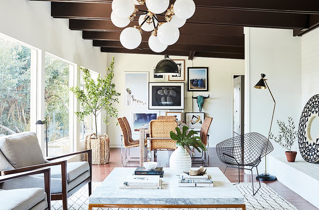 A vintage Bertoia chair—designed in 1952—nails the Mid-Century Modern aesthetic. What’s more, its open black frame allows the long room to flow from living to dining space without visual interruption or bulkiness.
