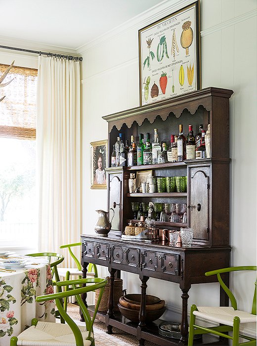 Since the kitchen is on the petite side, Bailey uses the dining room’s vintage hutch as a bar and serving station. She topped it with a German botanical chart she scored at the Round Top Antiques Fair. “I was just obsessed with it. I love how graphic it is.“
