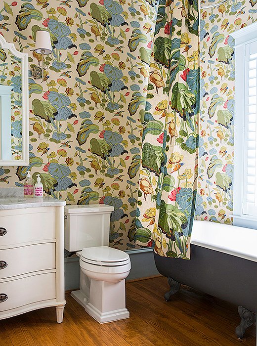 GP & J Baker’s cheery Nympheus pattern brightens up a small bathroom. The vanity and the claw-foot tub are new but fit the home’s Victorian vibe.
