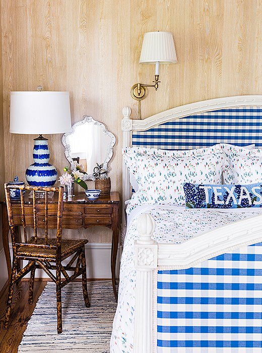 Another bedroom, which was once the home’s parlor, was decorated with a country-chic Gustavian bed upholstered in a gingham fabric. Since there are only two bathrooms, Bailey added a small vanity by the bed. “I wanted a little place to get ready that doubles as a bedside table.”
