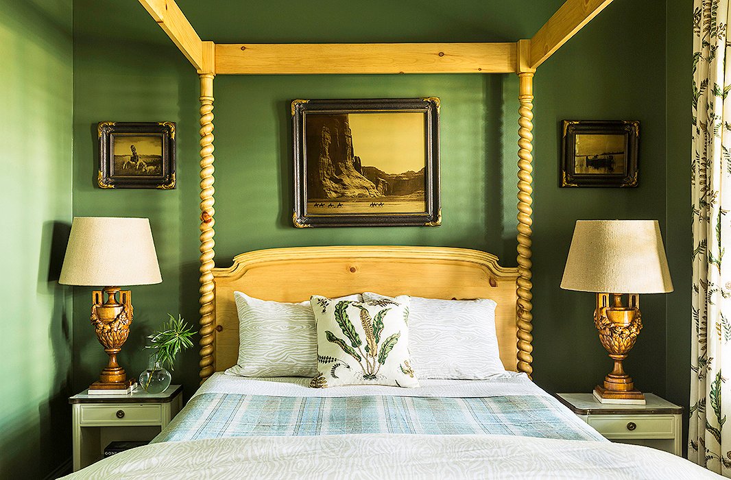 Like the kitchen, this guest room receives minimal light, so Bailey went with Benjamin Moore’s Alligator Alley for the wall color. “We wanted to make it feel like a cozy cocoon,” she says. The deep green provides a beautiful contrast to the natural-wood four-poster bed and the ornate table lamps.
