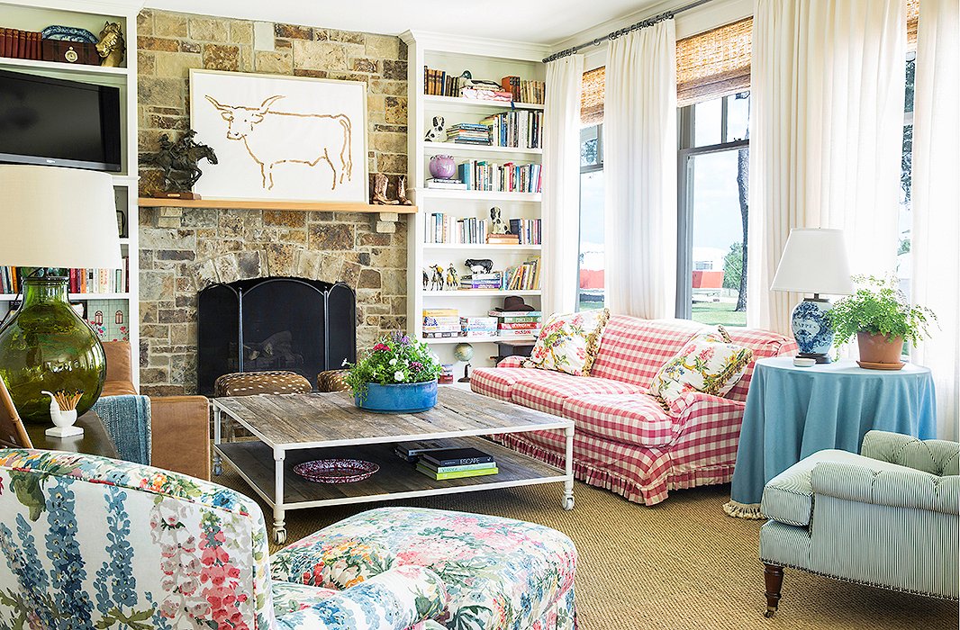 Bailey chose durable pieces for the living room, including an “indestructible” leather sofa and coffee table and a sofa slipcovered in a pink check. “Chintz and mixed patterns are great for hiding stains,” she says. Even the vintage toys and games fit the casual country vibe. “I think they are charming, so we keep them out on the shelves where the kids can easily access them—and put them away as well!”
