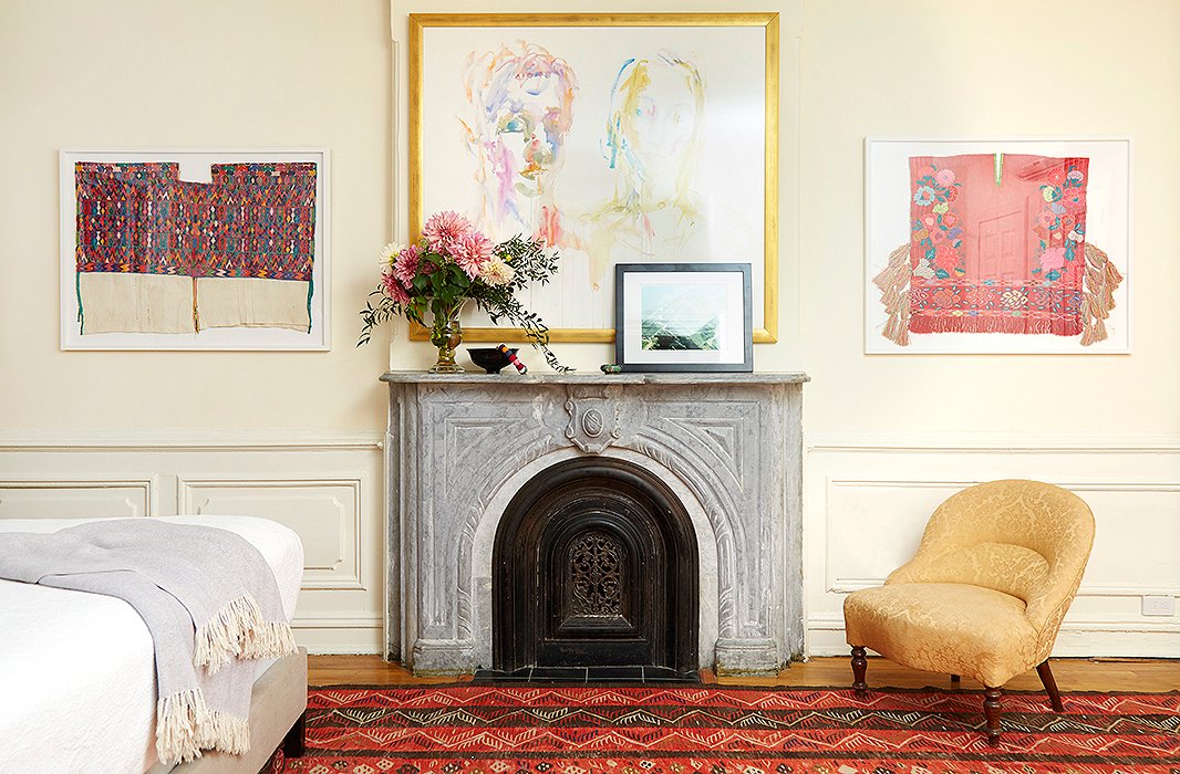 Carefully floating in Framebridge frames, two Mexican textiles became elegant wall hangings to complement a watercolor portrait. A photograph of a Haitian mountain leans against the mantel.
