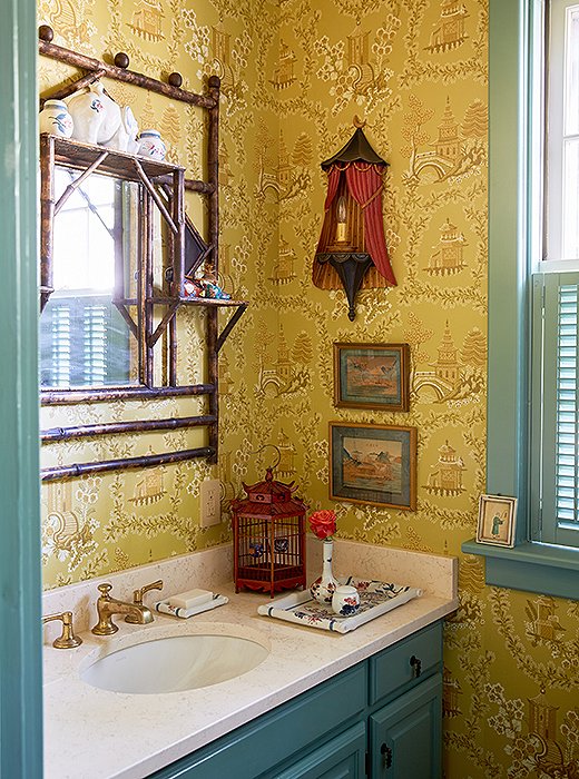 The designers used a vintage chinoiserie wallpaper to add impact to a small powder room and displayed objects and art on the walls and the vanity. “Bathrooms can have collections too,” notes Jason.
