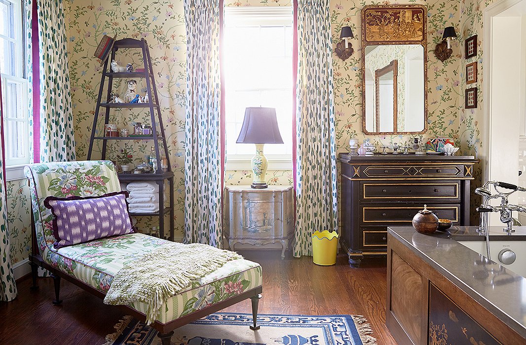 Antiques are used prominently throughout the house, even in the master bath. A vintage chinoiserie panel was set into the side of the tub, and they converted an 18th-century chest into a sink vanity. “You want to sit in the tub for hours and read World of Interiors and drink a martini,” Jason says. “It’s so warm and inviting.”
