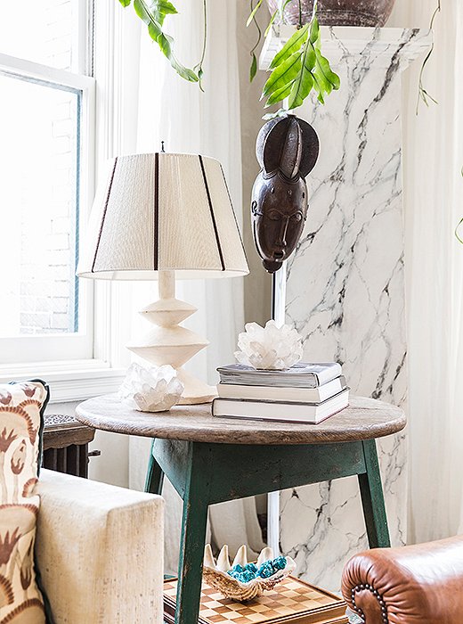 Every vignette carries a bit of family history. Katie snagged this “driftwood-y” table at Ruby Beets in Sag Harbor; the African mask was another of Averill’s travel finds. Katie’s brother found the shell in Hawaii when the two were kids, and the turquoise beads inside came from one of their mother’s necklaces.
