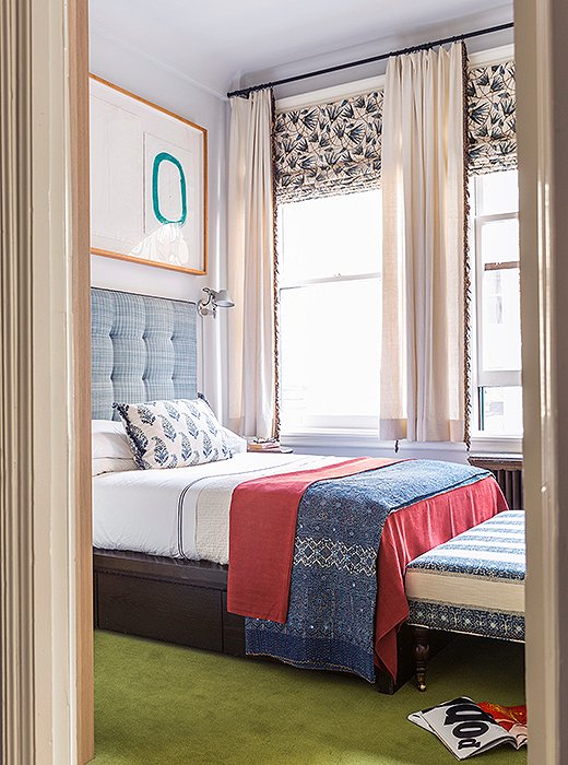 In the third bedroom, a printed ottoman and throw pillow complement curtain fabric from her first textiles collection. The papyrus-leaf pattern takes cues from ancient Egyptian wall paintings.

