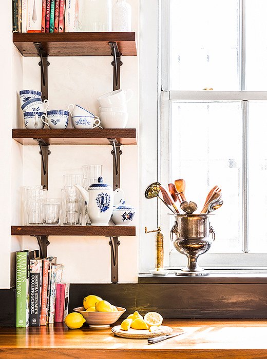 Open shelving provides space for pieces in constant rotation. Katie describes her entertaining style as “low-key but comfortable.” Whether she’s serving a spread of ready-made cheese platters or a home-cooked risotto, the vibe is casual: Guests pitch in with prep, and parties spread throughout the space.
