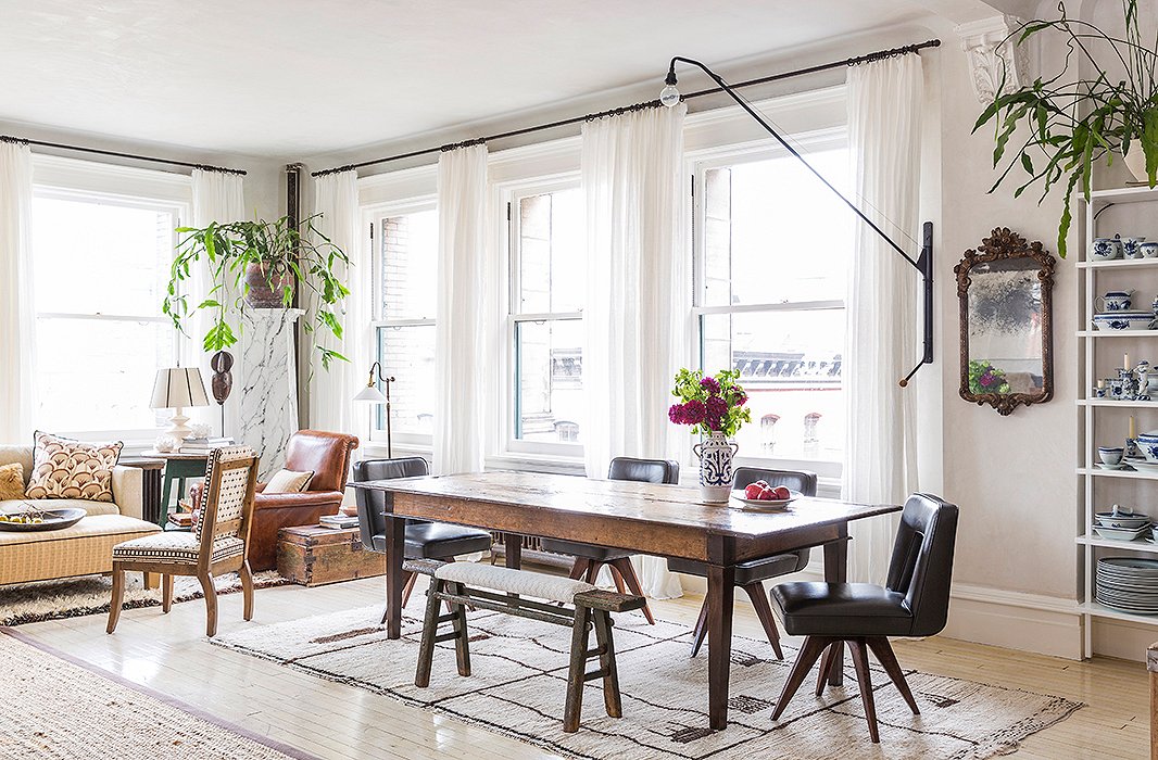 Custom midcentury-style dining chairs and a vintage bench surround the table, used for work as well as family dinners. Framing the space are two night-blooming cereuses, grown from cuttings of a plant owned by Averill’s grandfather in the 1920s. “They’re kind of crazy and a little Miss Havisham, but that’s part of living with someone, right? We all find room for our stuff together.”
