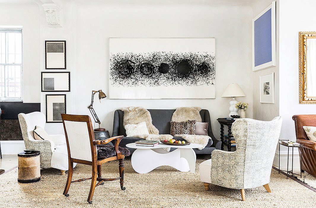 To the right of the kitchen, this seating area is the go-to spot for predinner cocktails. It’s also home to some of Katie’s favorite artworks, most of which have been collected or gifted over decades. A monochromatic palette pulls together a diverse mix of furniture styles.
