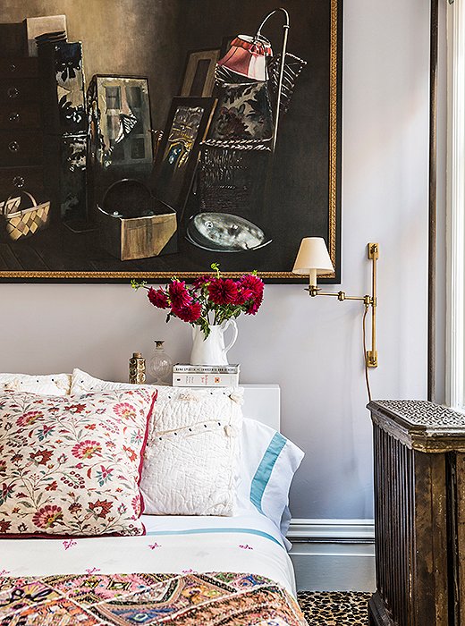 Pillows and quilts in varying patterns and colors feel perfectly mismatched in this eclectic space. Photo by Lesley Unruh.
