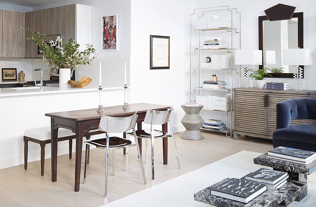 The vintage French table was the perfect size for the dining area. “Because it’s so Old Worldly, we needed to counterbalance that with something really modern and sleek,” David says. He chose a pair of chrome chairs to give that contemporary contrast and placed a bench on the other side of the table to maintain the visual flow into the kitchen.
