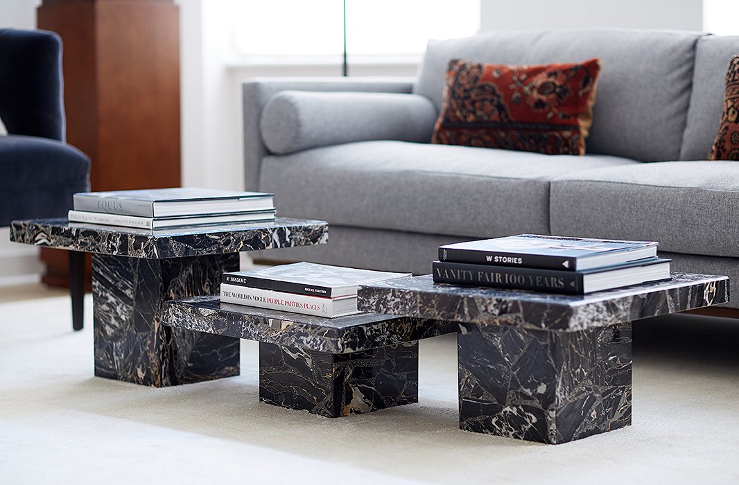 The coffee table is actually three side tables clustered together. “It anchors the room and provides a sculptural touch,” David explains. “I just wanted something really clean and simple. I think that those tables are almost like pedestals.”
