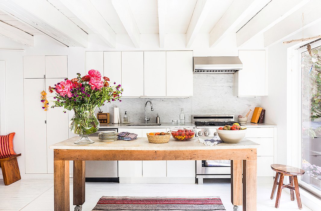 A slab of marble previously used for still-life photo shoots was transformed into a rolling kitchen island. Because the house is relatively narrow, Jenni wanted to have the option to move the island rather than install it in a fixed location. “In a small space, it’s really important that you don’t have a lot of things that feel heavy or weighted or cluttered,” she says. “I like a room to feel open and pretty minimalist.” 