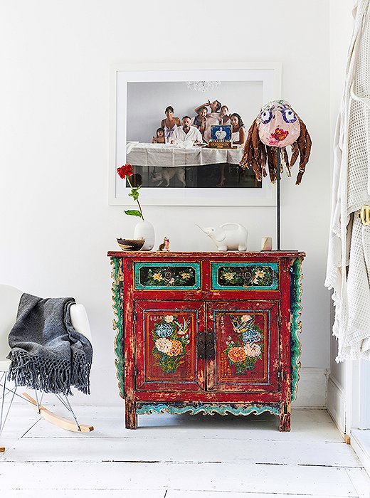One of Jenni’s favorite pieces in the house is the portrait of family and friends that hangs in a hallway above a vintage Chinese chest. “It just kind of captured everybody so perfectly,” she says.
