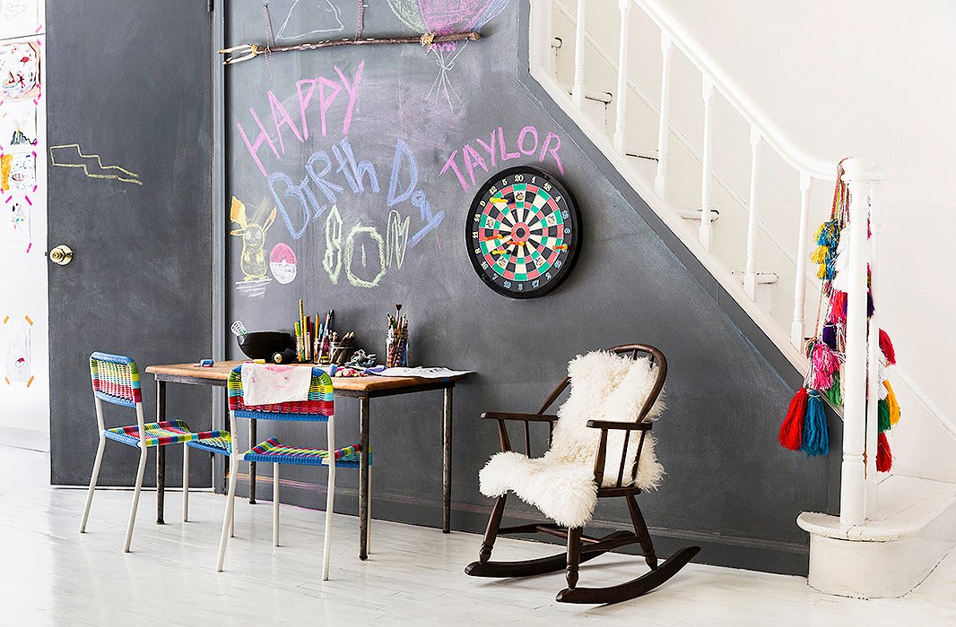 “I always try to have an art station for the kids in the central living area,” explains Jenni, who set up a spot for painting and drawing complete with a chalkboard wall. “That is the one kid-friendly aspect that I make sure to integrate in.” 