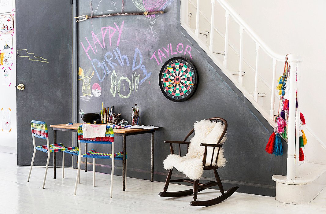 “I always try to have an art station for the kids in the central living area,” explains Jenni, who set up a spot for painting and drawing complete with a chalkboard wall. “That is the one kid-friendly aspect that I make sure to integrate in.”

