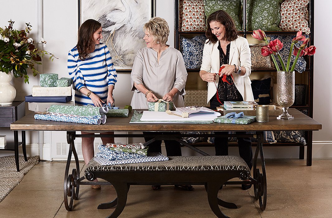 Holiday extends beyond the home for Bunny, who sets a welcoming seasonal tone in her showroom too. And every year, she gets her team in on the wrapping fun for gifts that are at hand when special guests stop in. Here, Bunny enlists the help of her design aides, Audrey Margarite and Jennifer Potter.
