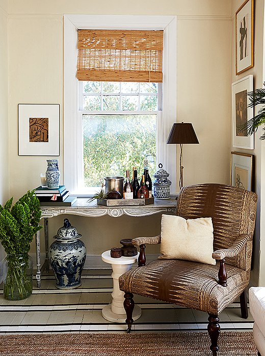 William transformed his grandmother’s console table into a chic bar that suited his style. “I’m not crazy about a mahogany Queen Anne–style feminine piece of furniture, but it’s my grandmother’s. So I painted it to look like a French Provincial antique piece.”
