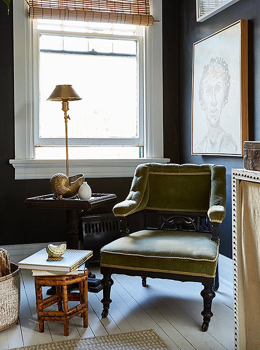 He arranged a petite seating area in the corner of the bedroom with an antique armchair (“I love all the ornamentation on it”) and a square table he found at an estate sale.
