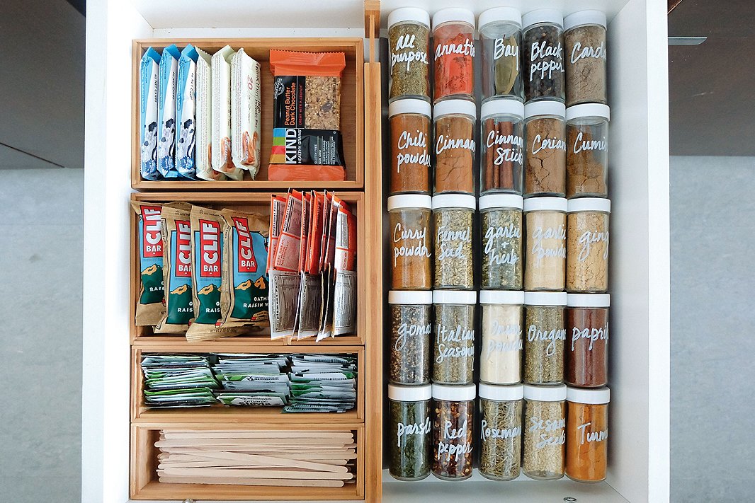 Shallow bins and alphabetical organization are key to keeping kitchen drawers tidy—especially if your home doesn’t have a dedicated pantry space.
