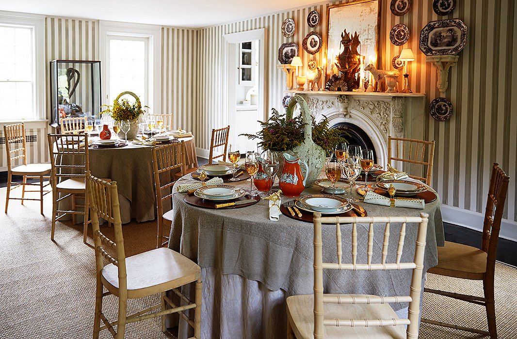 Beautifully detailed dishes, simple crystal stemware, round leather place mats, and flatware with bamboo handles—all in a rich palette—give the table a collected, classic look. Photo by Manuel Rodriguez.
