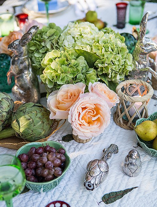 Bowls filled with artichokes, grapes, and pears add lush color and eye-catching shapes to the table.
