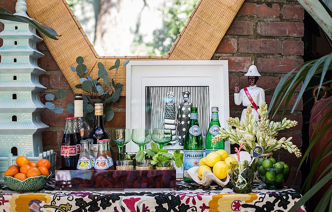 A Bahamian policeman figurine stands watch over the bar—and sparks conversation. “I think not everything has to be perfect. It’s fun to have things that are a little bit out of place,” Rebecca says. The suzani textile was a gift from Rebecca’s godfather, the interior decorator Alberto Pinto.
