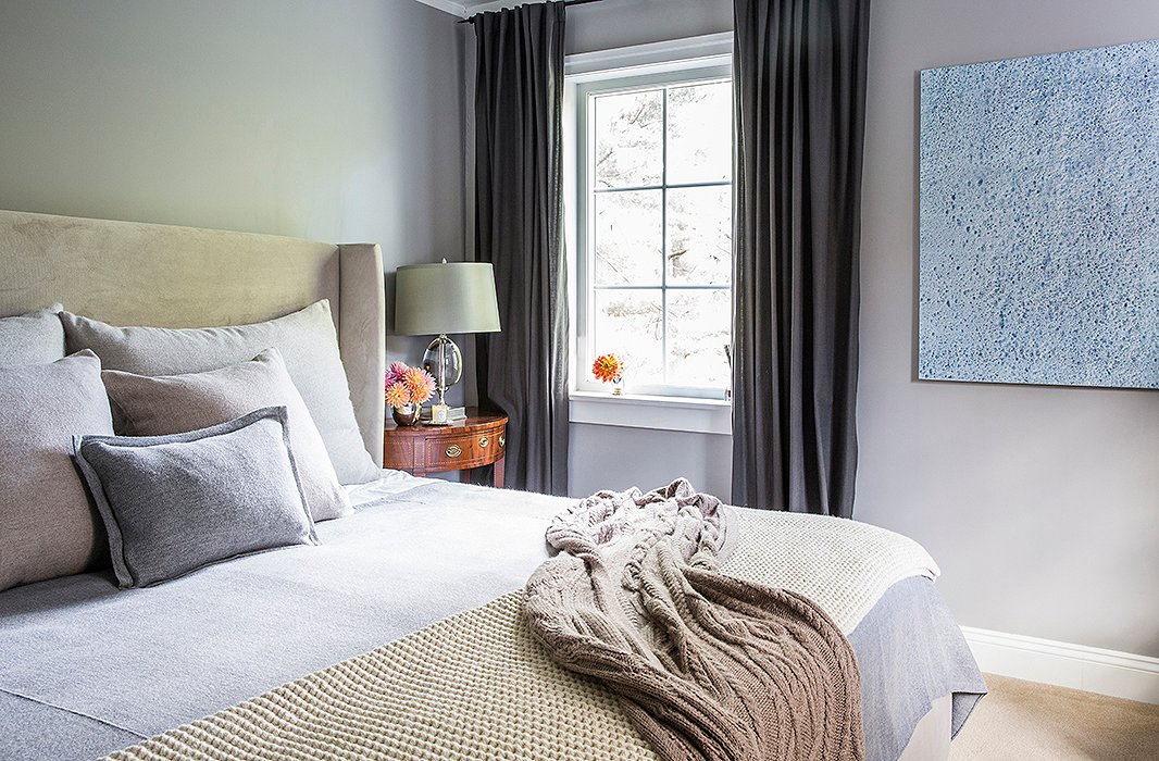 The master bedroom is part of the addition that the couple built onto the farmhouse. Soothing shades of gray and lush textiles make the space a nightly retreat from their busy lives. “It’s really just for sleeping, because we’re on the go all the time,” Alicia says. “It’s not like we have time to lounge with four kids!”
