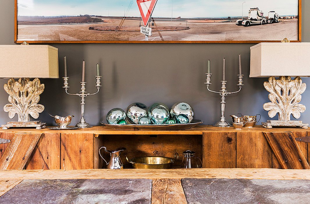 A sideboard—also made of reclaimed barn wood—displays serving pieces and lamps that Alicia found on One Kings Lane. While weekday meals are served in the kitchen, the family moves into the dining room on the weekends. “We’ll lay out a nice breakfast for the kids and just hang out there.”
