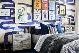 Nikki had a lot of fun with the palette in the room of La La’s son. She hung together multiple pieces of art alongside the jerseys of Kiyan’s father, Carmello Anthony. 
