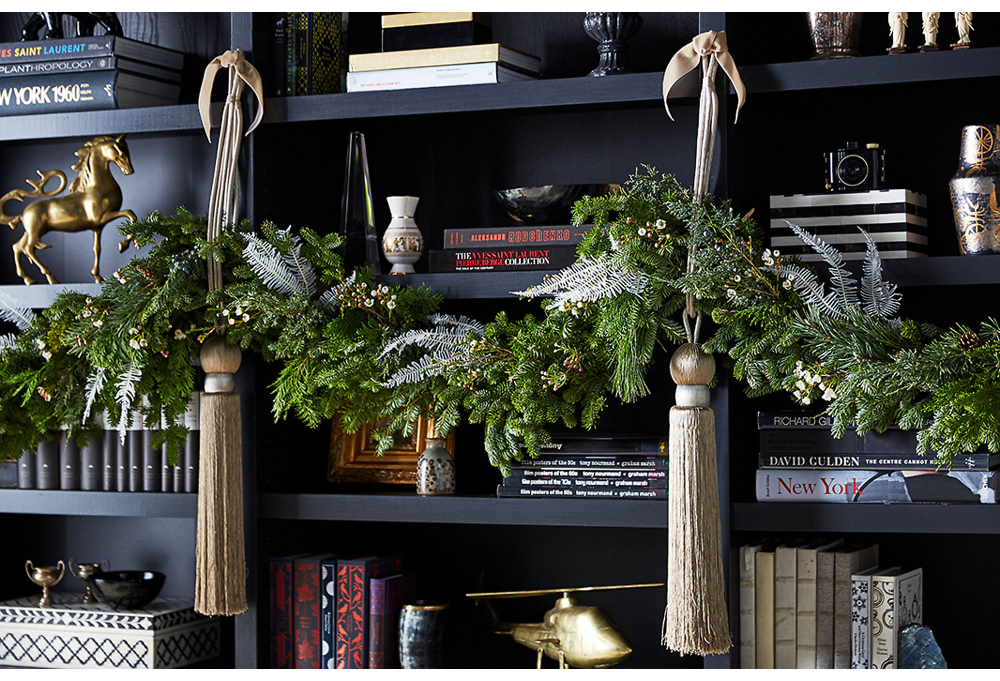 Here you can see how faux sprigs bring extra texture to a real garland. Adding in interesting faux elements to real pieces is a great way to customize your look. Photo by Manuel Rodriguez
