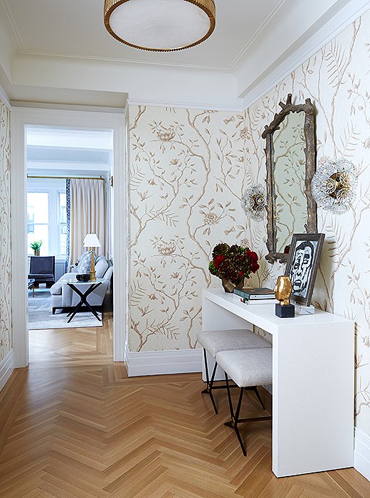 Graceful wallpaper makes an impact in the entry. “We wanted something that felt a little bit feminine but clean and simple at the same time,” says Vivian.
