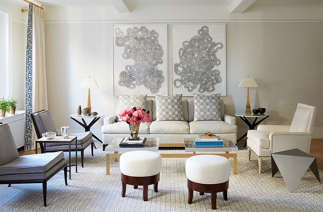 A pair of Tara Donovan prints set the symmetrical tone for the polished living room. The homeowners “have a passion for art and antiques, so we wanted to start a collection for them at the same time,” says Alyssa.
