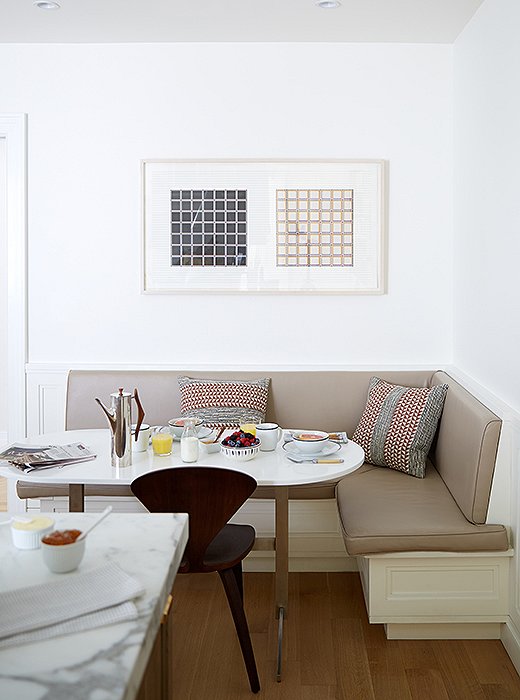 The family’s four boys love piling into the breakfast nook for meals and homework. Alyssa and Vivian paired a banquette upholstered in kidproof vinyl with a custom table.
