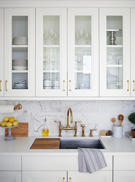 Rich materials including brass and marble accent the kitchen. “Brass is such a warm metal,” says Vivian “One of the ways we accomplished that warm feeling in the apartment was by using brass.”
