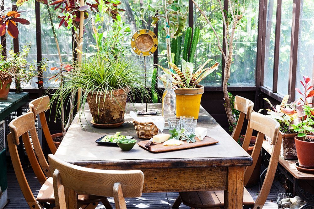 A dining table doesn’t need to be precious if it’s in an outdoor environment. “If you’re at a garage sale and looking at an ugly table, paint it black, stick it outside, and let it age,” says Stansfield.
