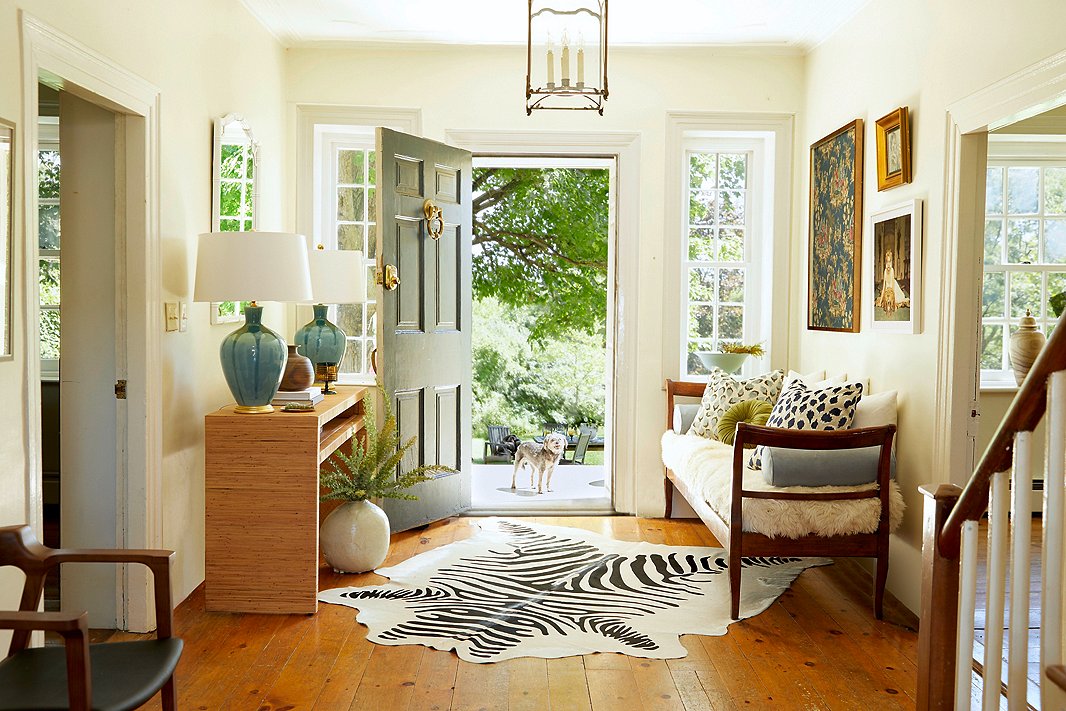 A zebra-print hide rug, hand-thrown table lamps, a Dawn Wolfe chinoiserie print next to a Slim Aarons photograph, a sleek bench topped with a toasty sheepskin and a bevy of pillows (including the dotted Dahlia in two colorways): What do they have in common? Stellar craftsmanship, classic themes, and an emphasis on quality materials that allow them to work beautifully together.
