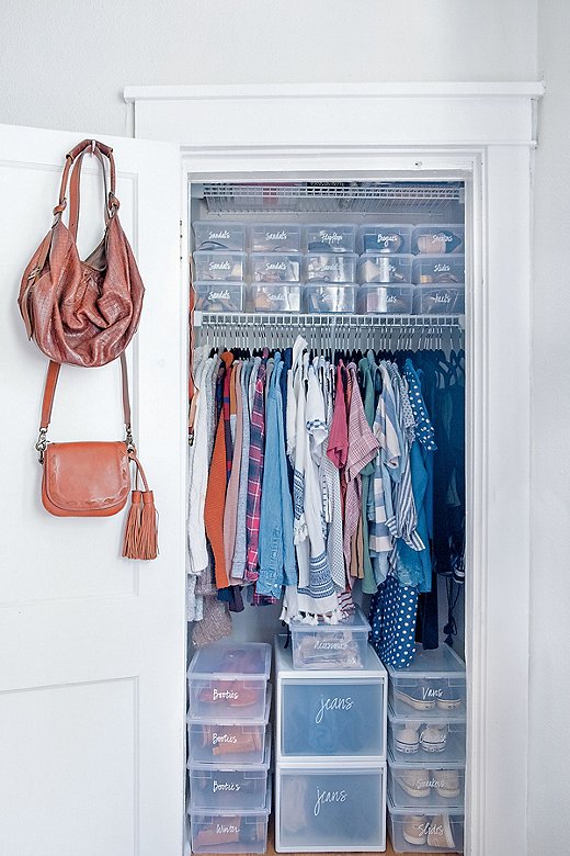 A makeshift “chest of drawers” made of deep plastic bins is a genius solution for closet floor space, and ensures items will remain dust-free.
