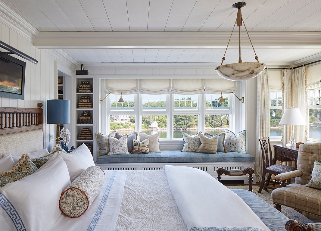“There’s definitely a lot of blue in our house,” Philip says. Since nearly every room looks out onto the water, he wanted to pick up the hues of the sea and the sky. “But it’s not a ‘blue’ house—it has more layers to it,” he adds. Here in the master bedroom, blue textiles and trims play off fresh white linens.
