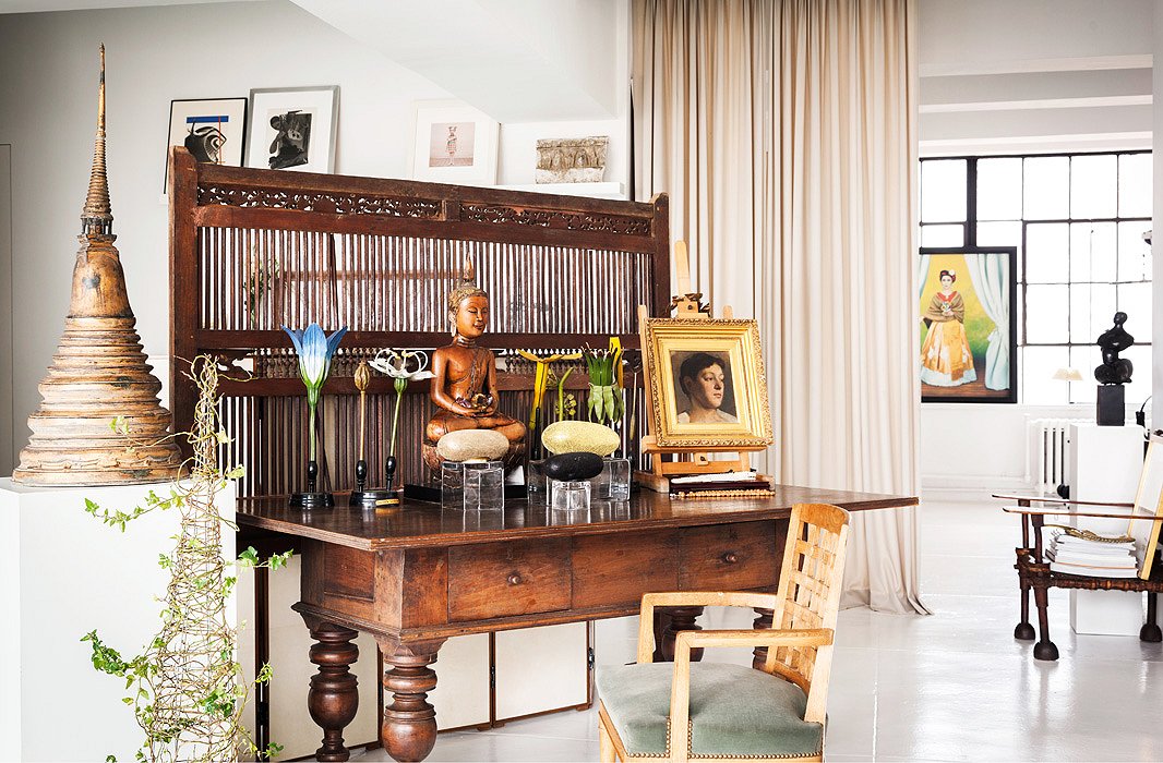 An Indonesian teak screen functions as a visual delineation between the entry and living areas. Once inside, visitors are greeted by ornamental flowers from Belgium and a Thai Buddha, both of which reside on top of an antique Dutch Colonial desk found in Sri Lanka.
