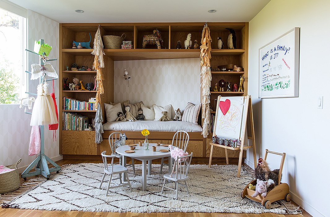 The couple designed James’s room with distinct “components.” In addition to a sleeping area, they wanted a space for “playing, reading, and being cozy,” says Jessica. Jed built the table, which is encircled by mismatched chairs scored at flea markets. The “set” is unified with a light gray Farrow & Ball paint. 