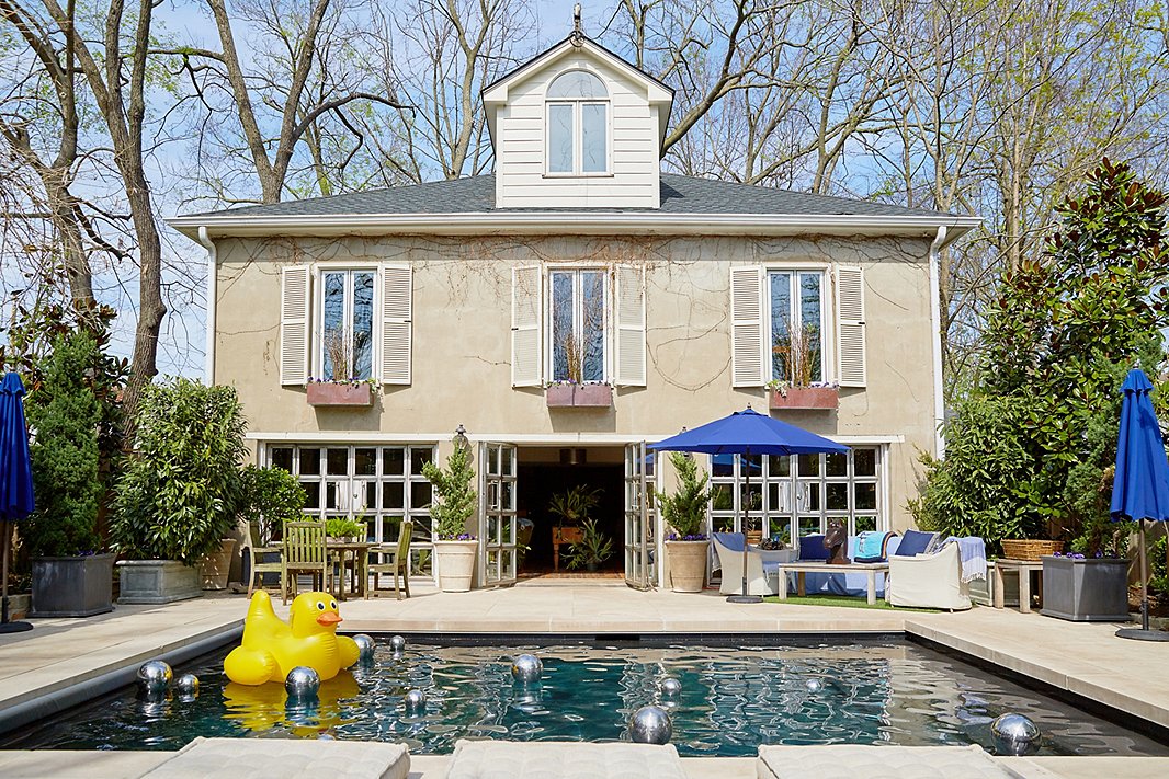 A collection of silver orbs unexpectedly accents the surface of this pool—a high-low contrast to the cheeky pool float. Photo by Tony Vu.
